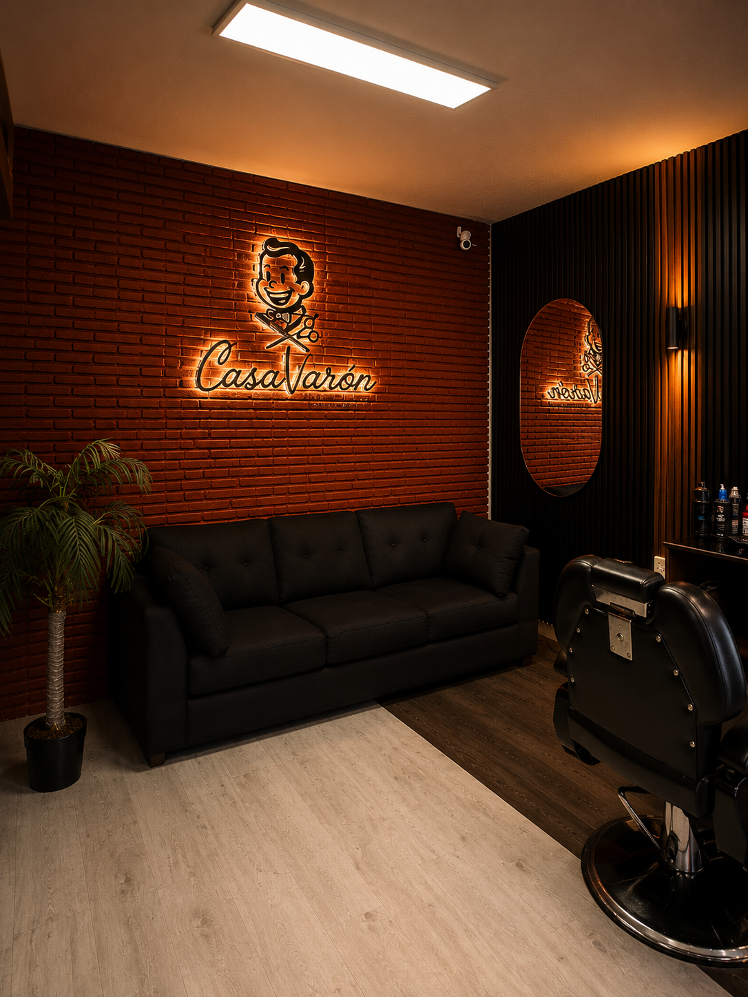Sala de espera con pared de ladrillo y logo de neón